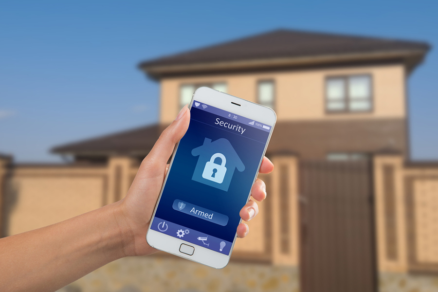 Cell phone screen displaying security armed with a house in the background